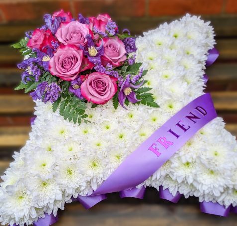 Floral cushion with lilac ribboning 